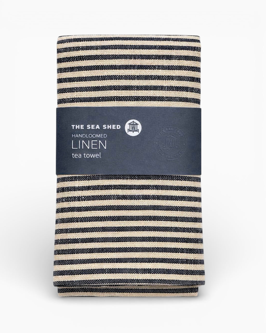 Striped linen tea towel with 'The Sea Shed' label on a white background. Striped linen tea towel
100% linen tea towel
Hand-loomed linen tea towel
Natural linen kitchen towel
Coastal linen tea towel
Linen dish towel UK