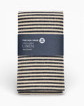 Striped linen tea towel with 'The Sea Shed' label on a white background. Striped linen tea towel
100% linen tea towel
Hand-loomed linen tea towel
Natural linen kitchen towel
Coastal linen tea towel
Linen dish towel UK