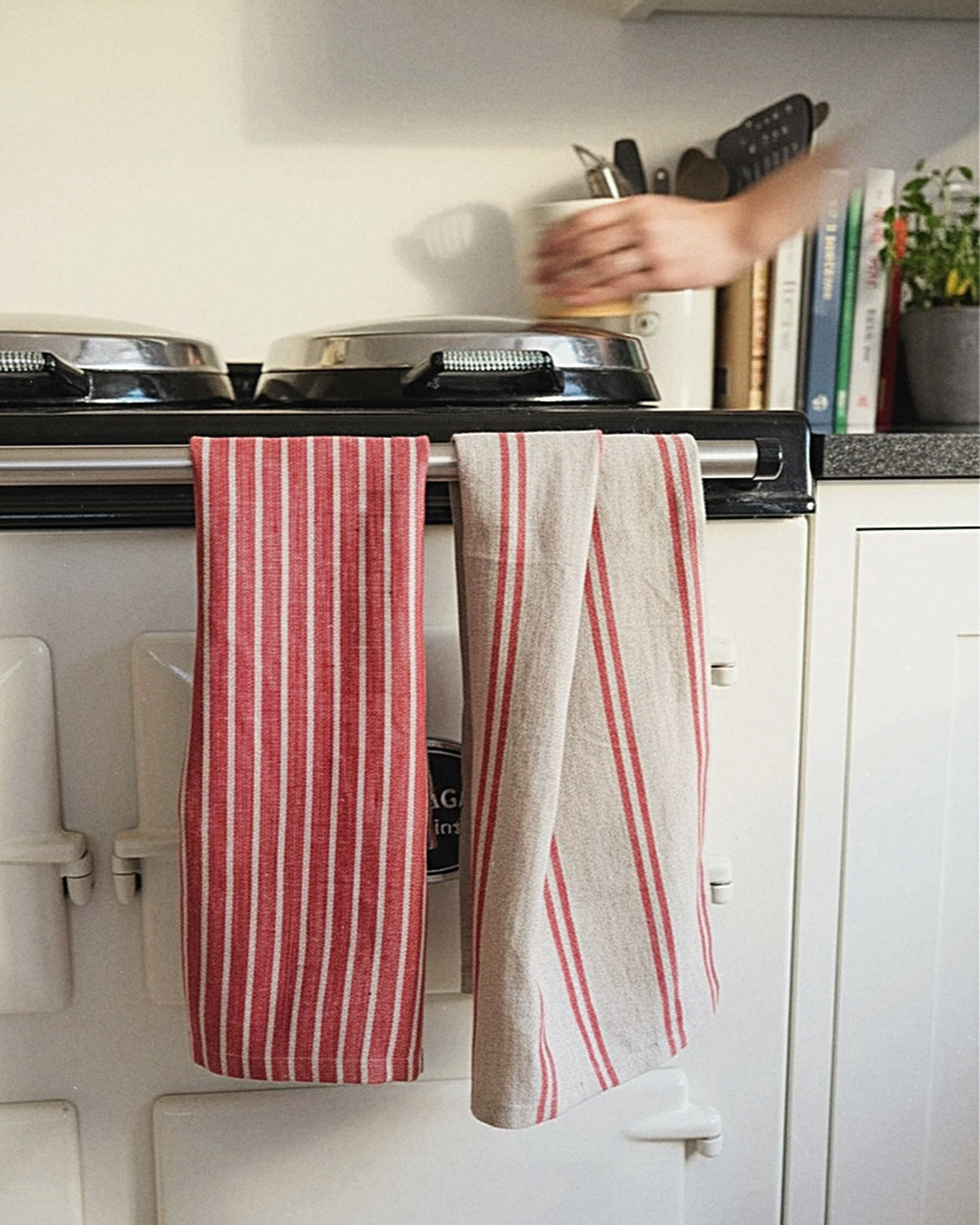 Red and white striped kitchen towels hanging on a stove handle with a blurred hand in the background. Striped linen tea towel
100% linen tea towel
Hand-loomed linen tea towel
Natural linen kitchen towel
Coastal linen tea towel
Linen dish towel UK