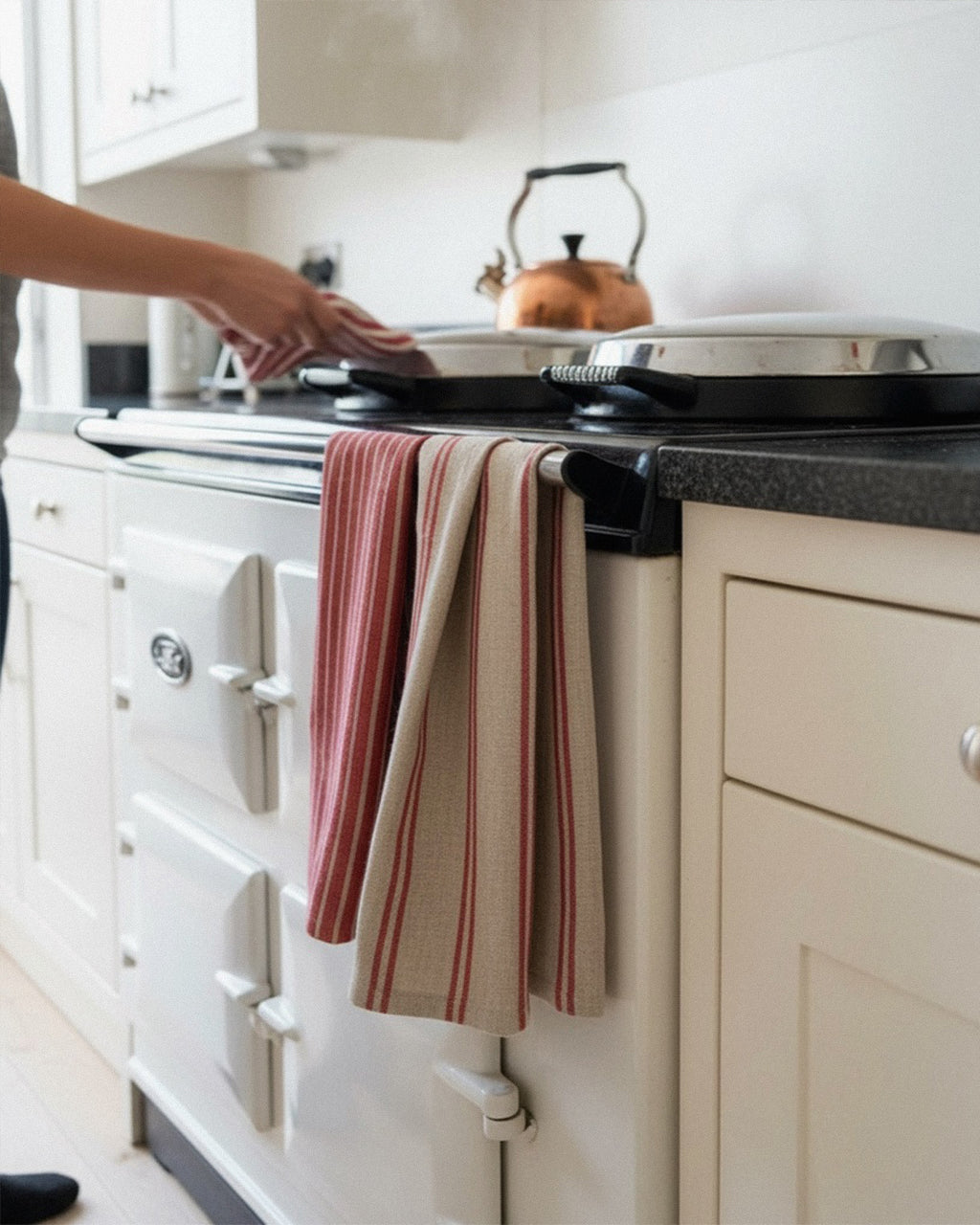 Person using a stove with a striped towel hanging on it in a kitchen.
Striped linen tea towel
100% linen tea towel
Hand-loomed linen tea towel
Natural linen kitchen towel
Coastal linen tea towel
Linen dish towel UK