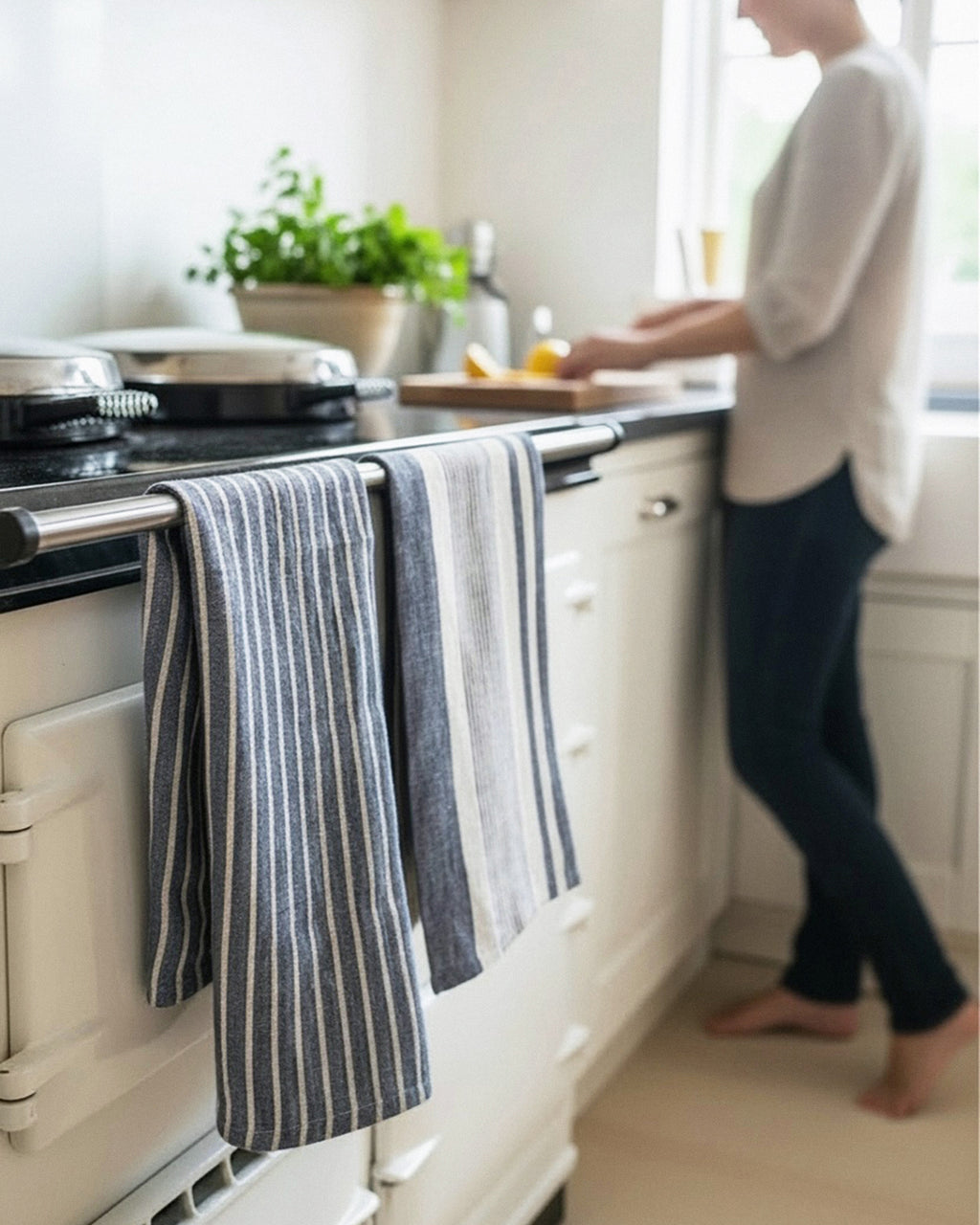 Person standing in a kitchen with striped towels hanging on an oven handle. Striped linen tea towel
100% linen tea towel
Hand-loomed linen tea towel
Natural linen kitchen towel
Coastal linen tea towel
Linen dish towel UK